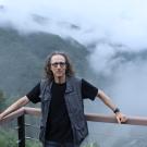 Dr. Foster in front of a foggy mountain