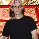 a photo of a man wearing a bandana on his head.